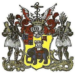 a coat of arms featuring two racist depictions of African people, and an elephant in the middle