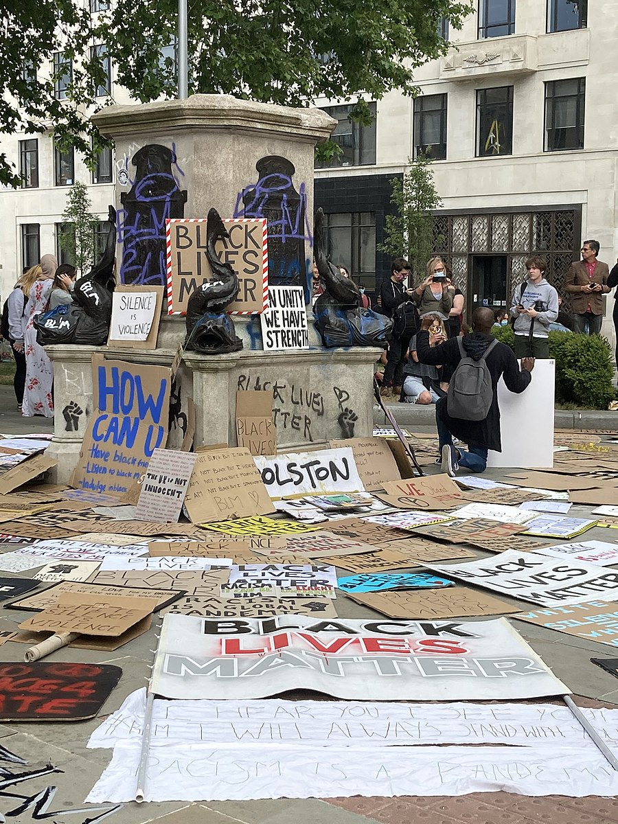 The empty plinth where the Colston statue once stood, now covered in graffiti and "Black Lives Matter" signs