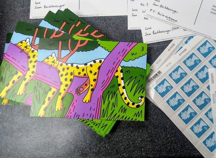 Postcards with a cartoon illustration of a sleeping leopard lying next to a sheet of postage stamps