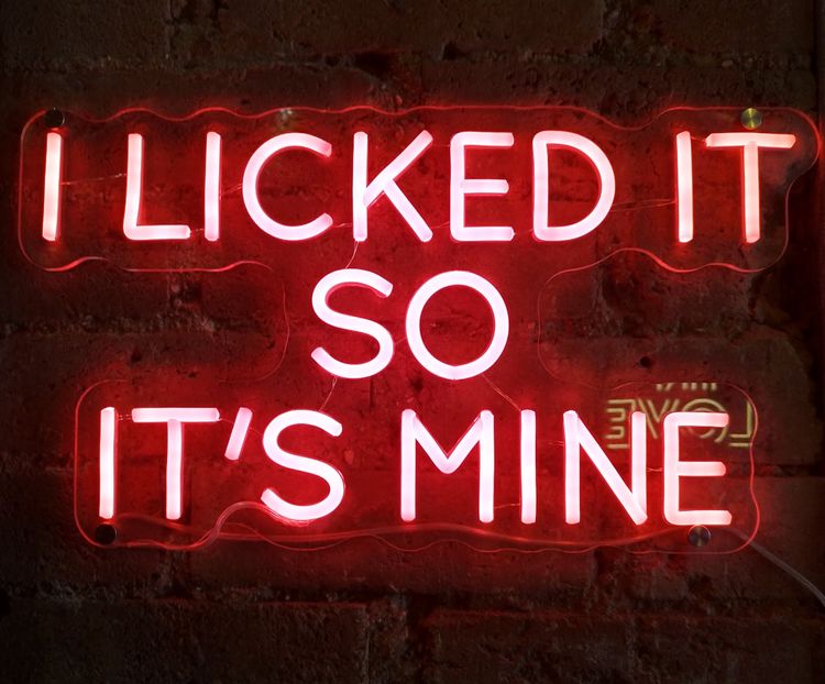 Neon sign saying, "I licked it so it's mine"