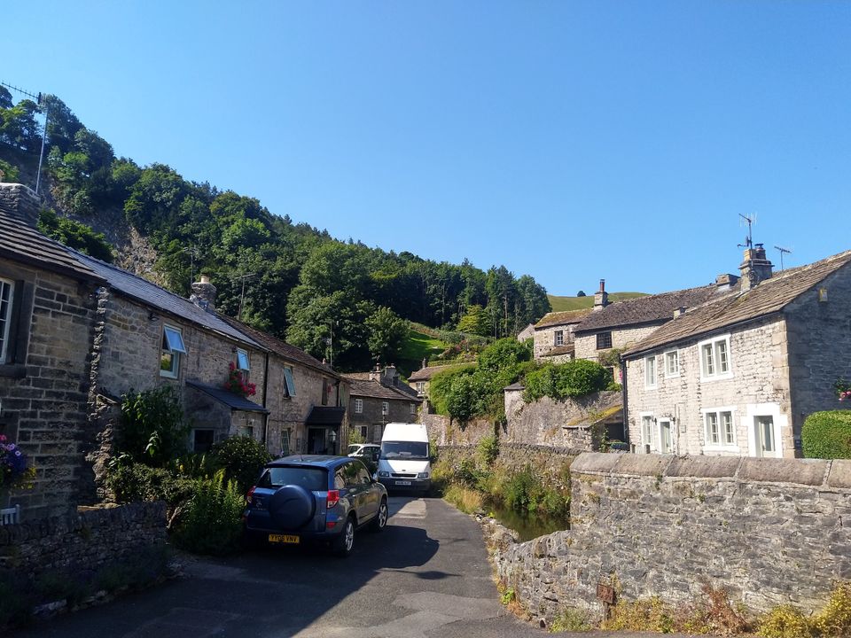 A view down a street in Castleton, with old stone houses