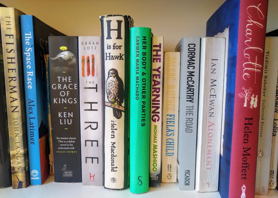 A shelf of books: John Langan's The Fisherman. Alex Latimer's The Space Race. 